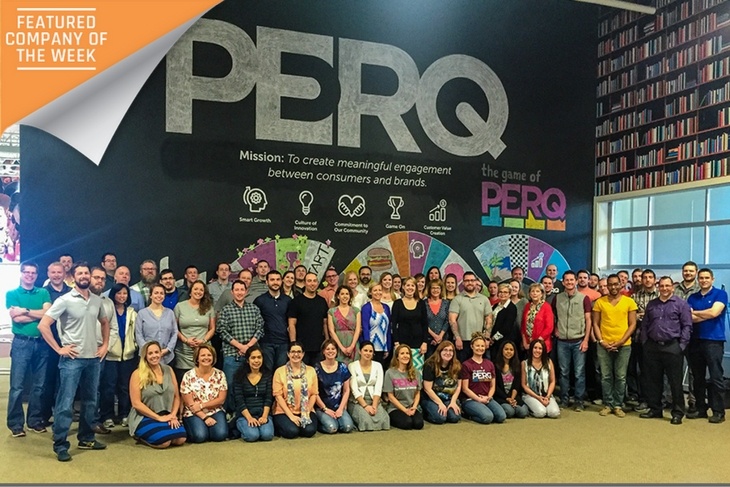 The entire staff team at PERQ gathered in front of their iconic “chalk wall” to celebrate being named to the IndyStar Top Workplaces list for 2016.
