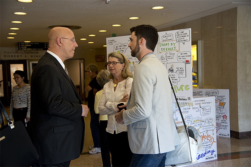 Purdue System CIO Gerry McCartney (left), chats with attendees including TechPoint CEO Mike Langellier at the 2014 Dawn or Doom conference.