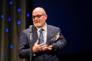 Brian Belch accepting his Mira award