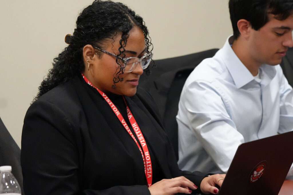 Degmarie Santiago prepares alongside Team 6 prior to giving their presentation at the October 10 MISO Xtern Challenge.