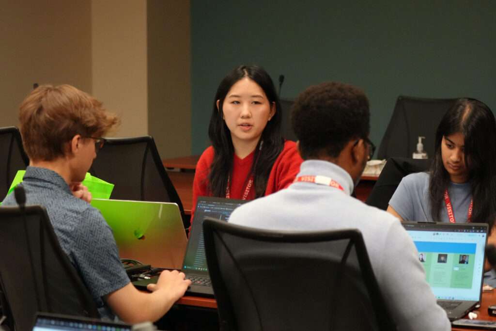 Team 10's Austin Vesich, Kloe Wang, Julius Choga, and Amruta Killampalli prepare to give their final presentation at the Xtern Challenge.