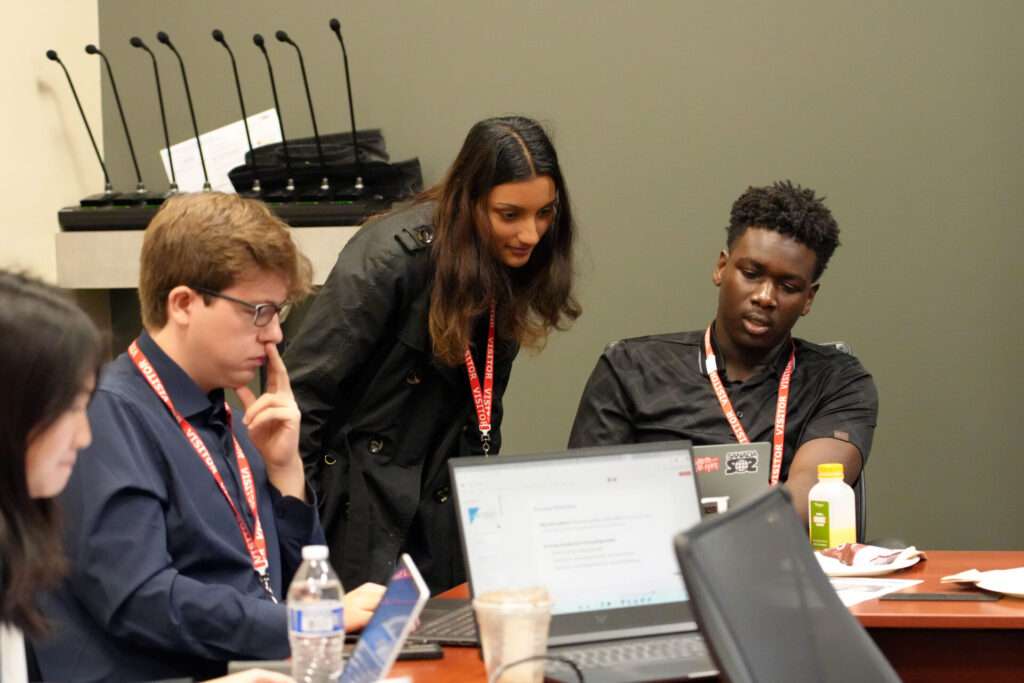 Team 2 members Cynthia Hu, Seth Poindexter, Shrishti Maurya, and Faris Ibrahim prepare for their presentation at TechPoint's Xtern Challenge, hosted by MISO.