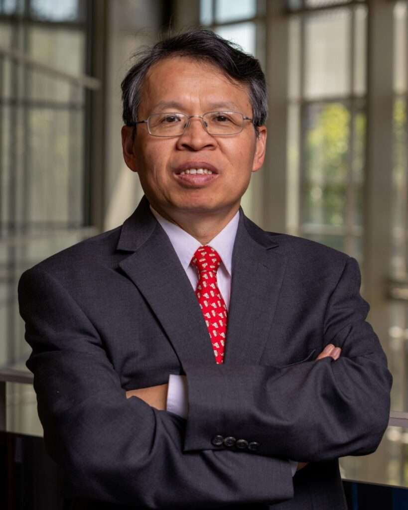 Portrait of Dr. Wenbin Yu, Milton Clauser Professor of Aeronautics and Astronautics at Purdue University, wearing a dark suit and red patterned tie.