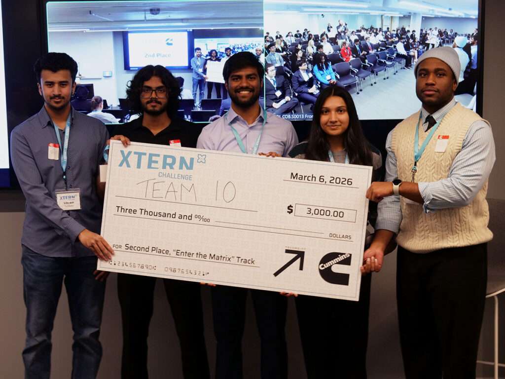 Team 10 poses with a ceremonial $3,000 check for second place in the Enter the Matrix track at the 2026 Xtern Challenge. Team members are Vikram Kavalipati, Sanketh Patel, Seno Sanjeev, and Somya Sakalle of Purdue University, and Sinclair Nzenwata of Ball State University.