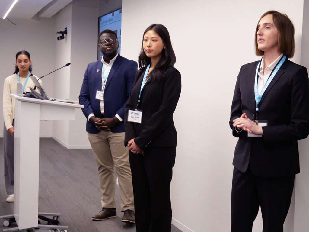 Team 12 presents during the 2026 Xtern Challenge. Team members are Ramani Satishkumar of Purdue University Indianapolis, Freddy Da-silveira of Ball State University, San Mi Mi Thant of Indiana University Bloomington, and Colleen Busher of Rose-Hulman Institute of Technology.