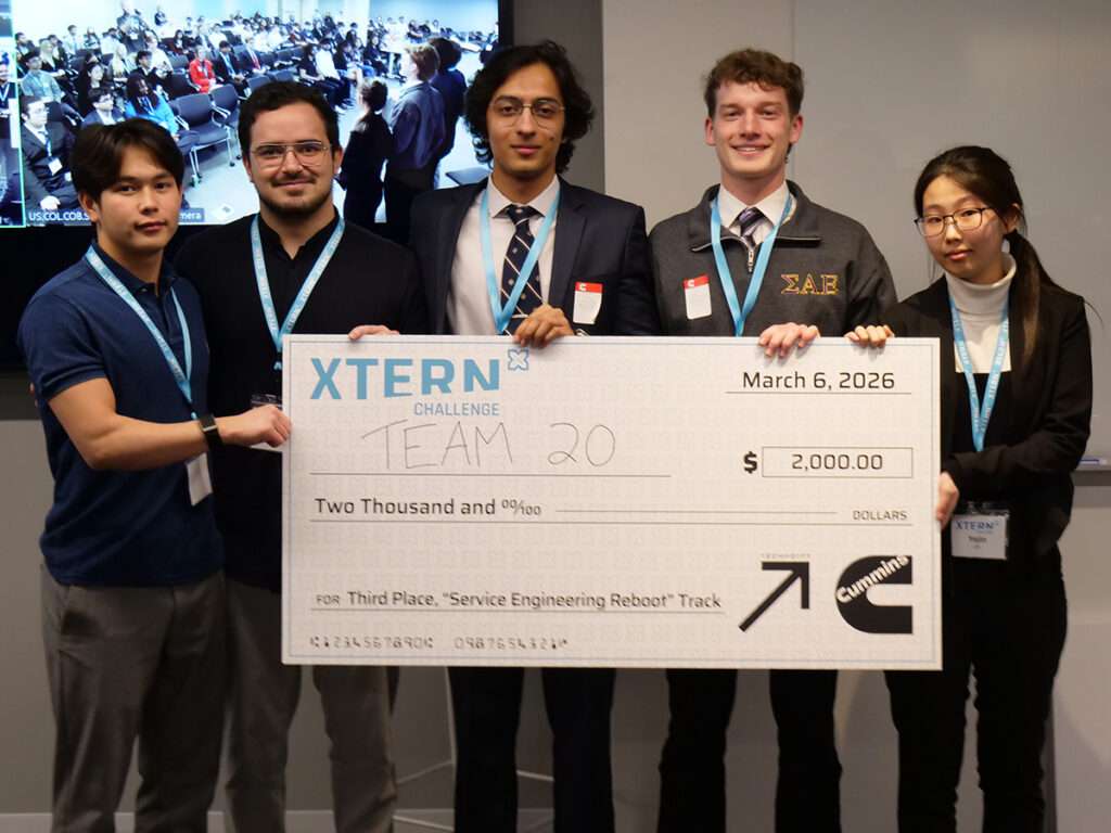 Team 20 poses with a ceremonial $2,000 check for third place in the Service Engineering Reboot track at the 2026 Xtern Challenge. Team members are Ibragim Tleukulov, Adam Amar, and Mian Abdullah of DePauw University, Nathan Vujaklija of Franklin College, and Yejin Oh of Purdue University.