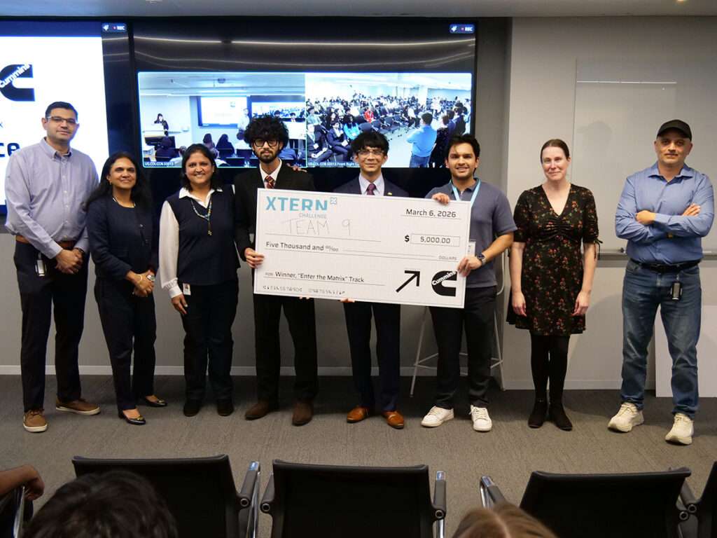 Team 9 poses with judges at the 2026 Xtern Challenge. Team members are Ameya Shukla and Tanay Patel of Purdue University and Samip Devkota of DePauw University.