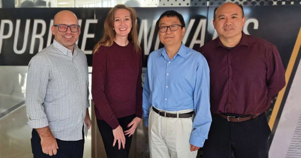 Mike Shepard, Nicole Adams, Nan Kong, and Baijian Yang stand together in front of a Pure Maverick sign. The four co-founders recently launched Leto Tech PBC, a technology startup focused on helping connect social workers’ clients with local social service providers.