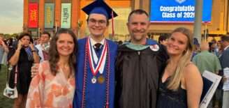 Nick Fishel stands with family at son's high school graduation.