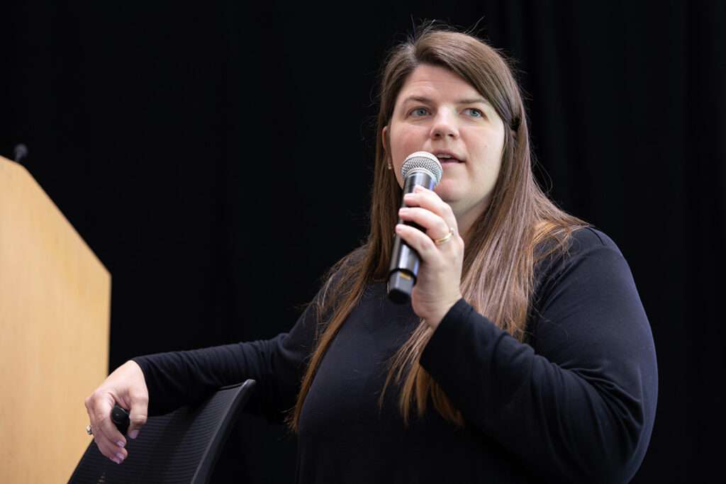 Sally Reasoner of TechPoint speaks into a microphone during a Community Connect event.